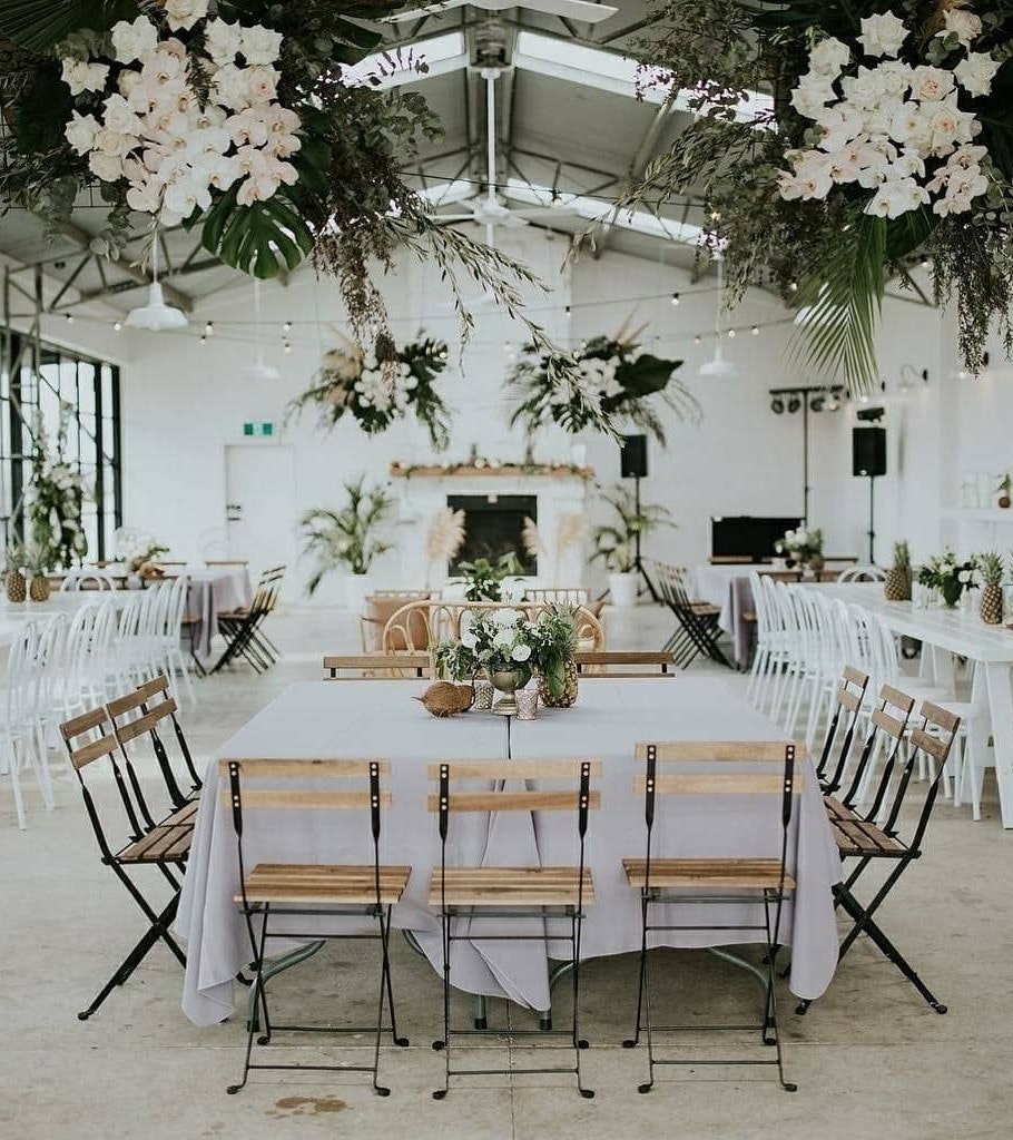 Wedding reception table styling inside barn.